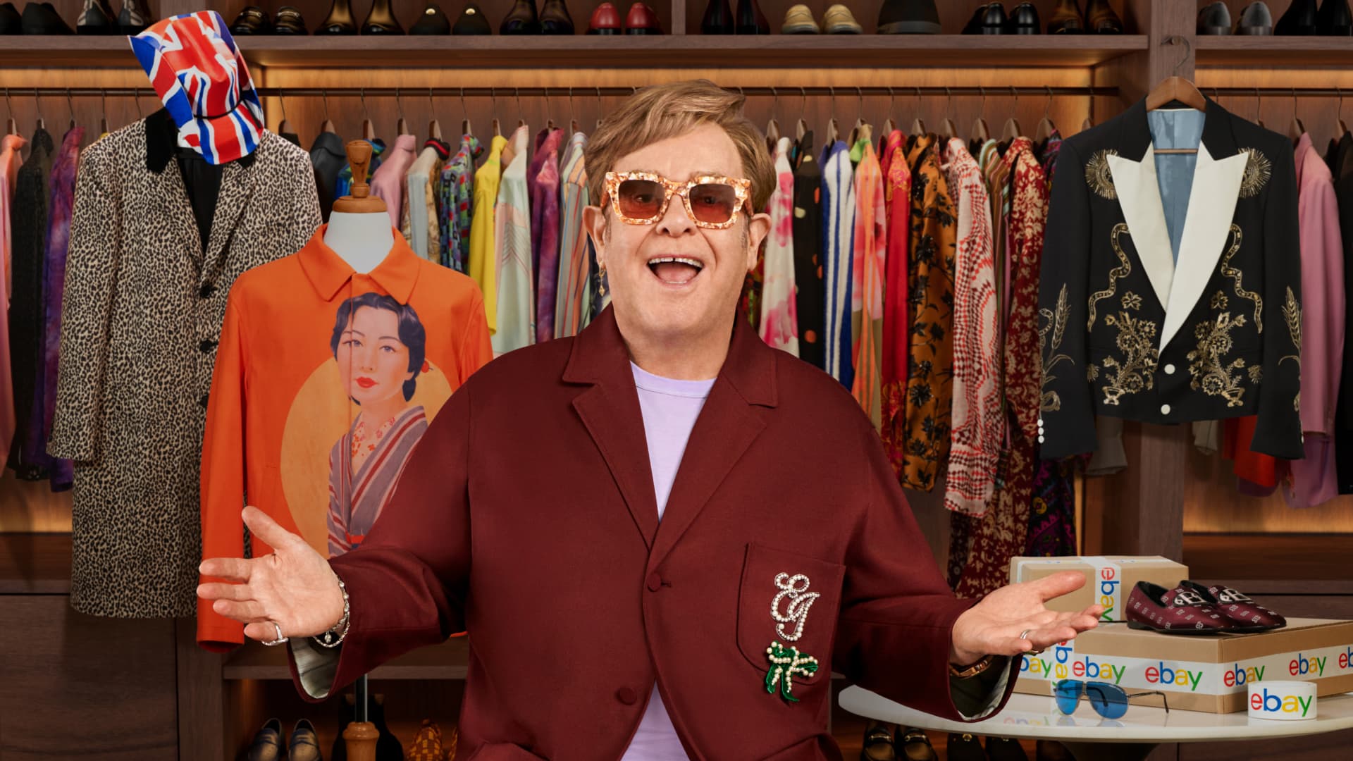 Elton John standing in a wardrobe room for the eBay charity sale campaign